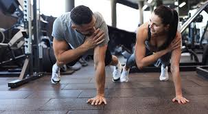 Sculpting Sleek Arms: The Essential Role of Cardio in Toning Without Bulking Up 1 Image of man and woman doing Cardio Bridport to tone their arms.